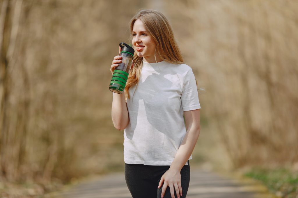 woman drinking water from bottle