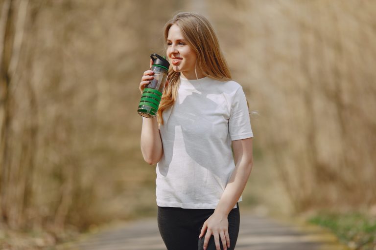 woman drinking water from bottle