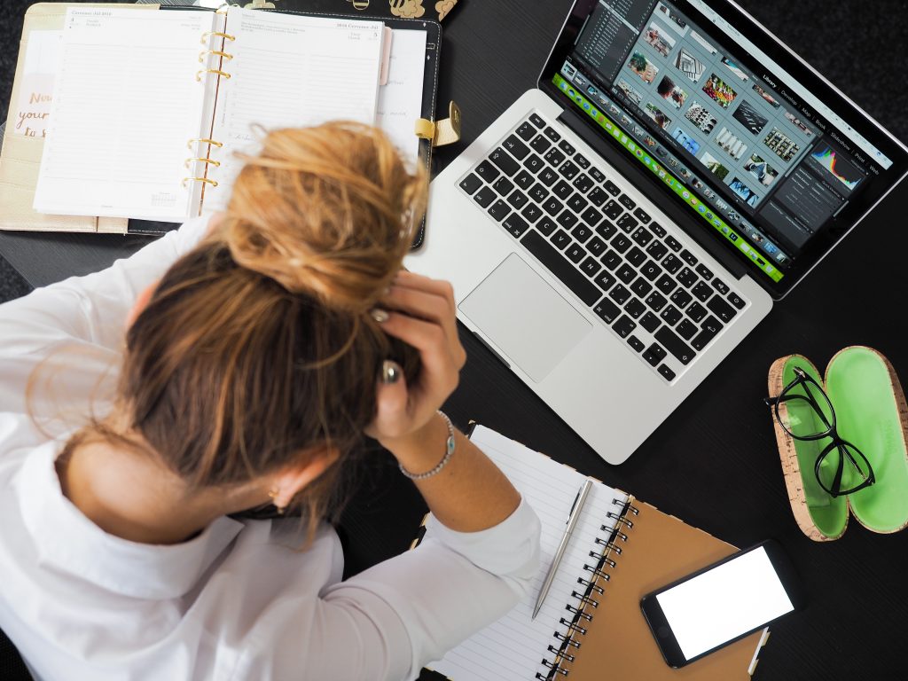 woman looking stressed at laptop