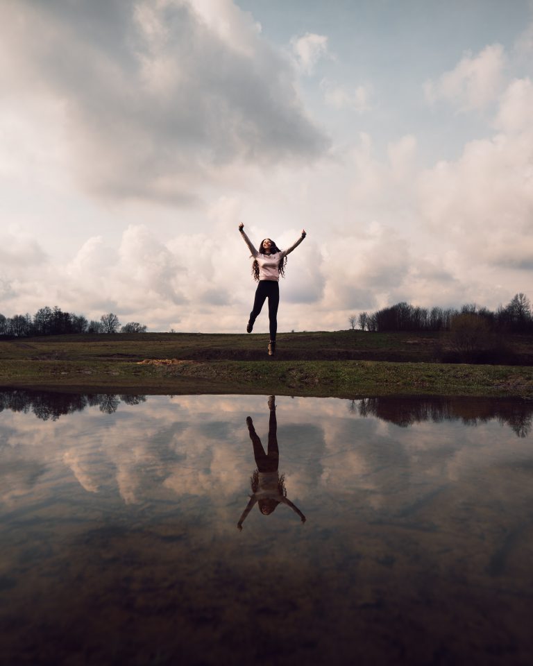 woman in front of lake with reflection
