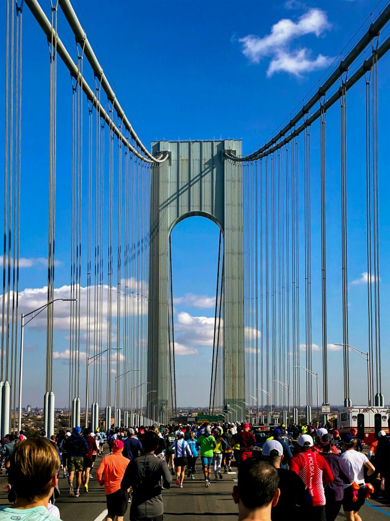 runners running over a bridge