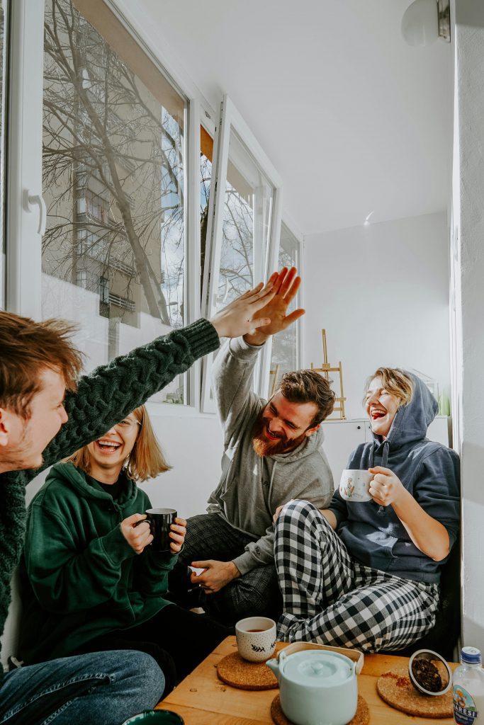 group of housemates high five