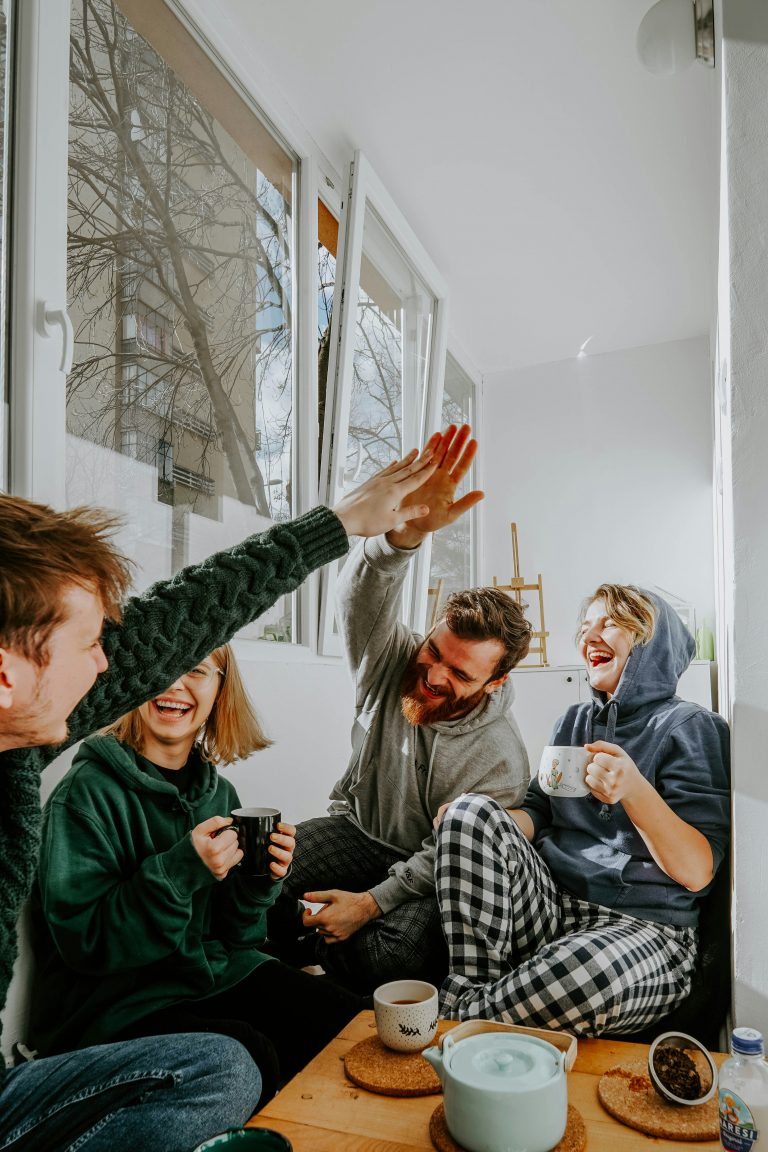 group of housemates high five