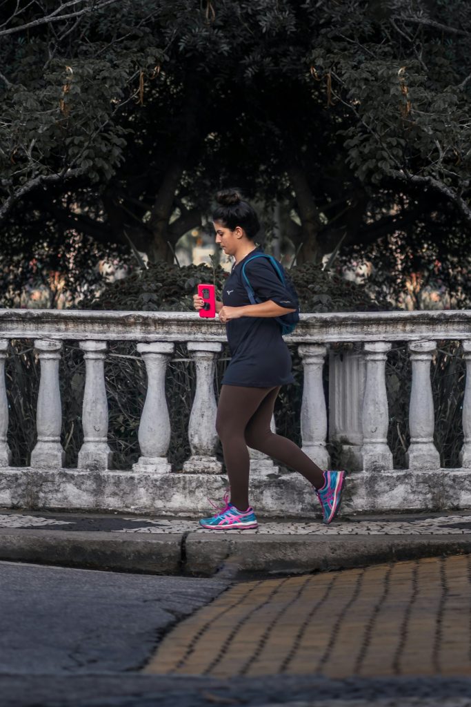 woman running holding phone