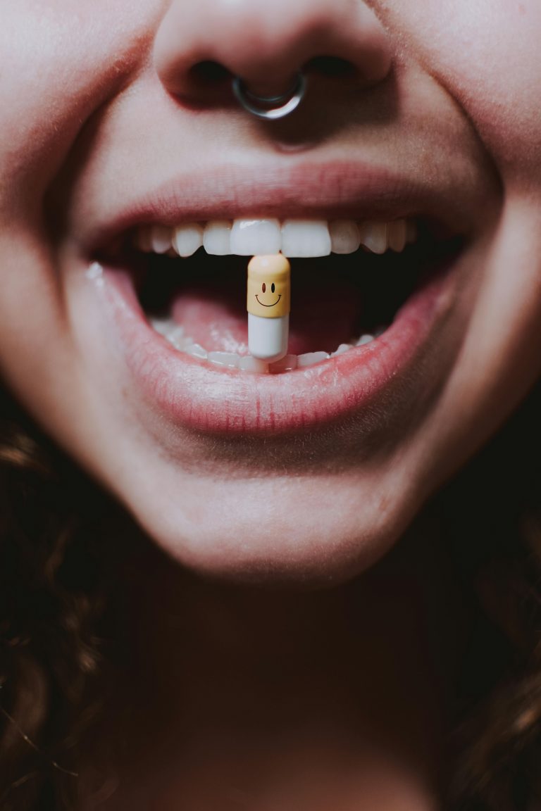 pill with happy face in mouth