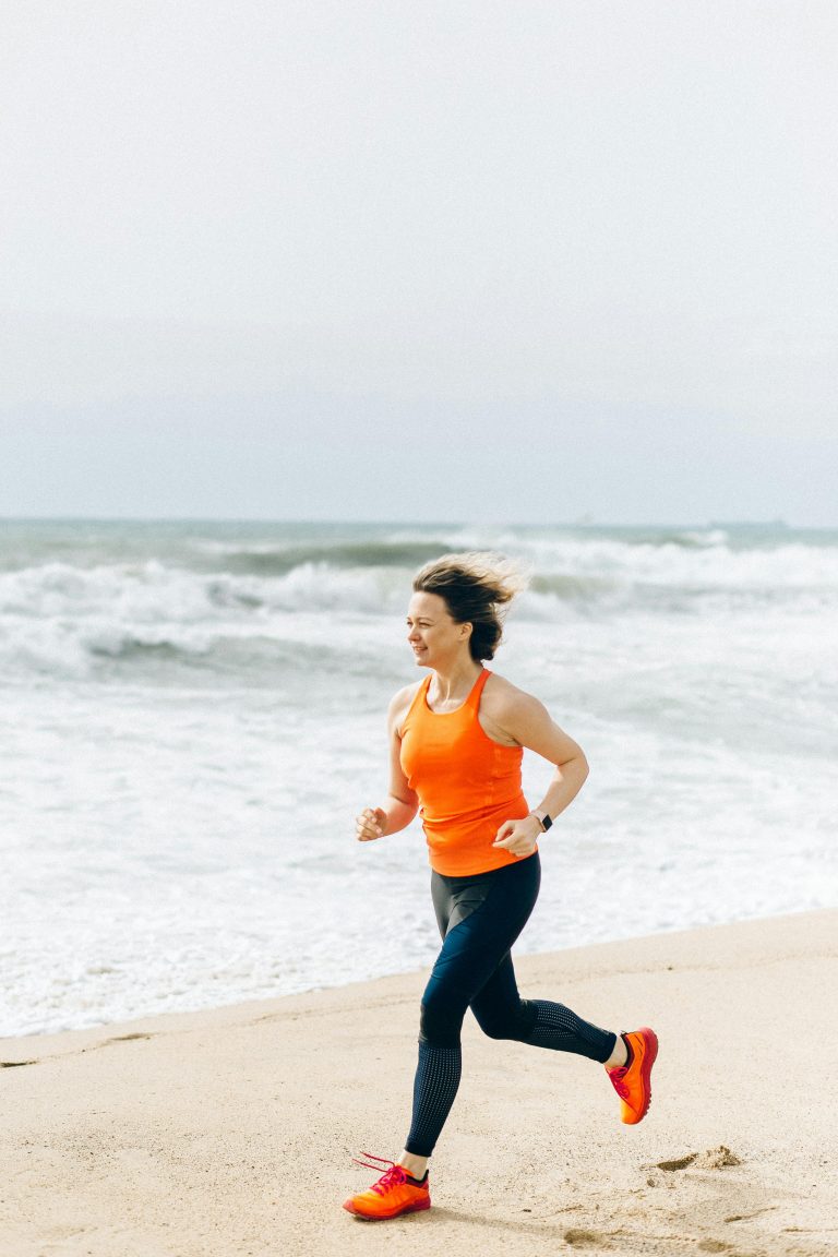 woman running along a beach