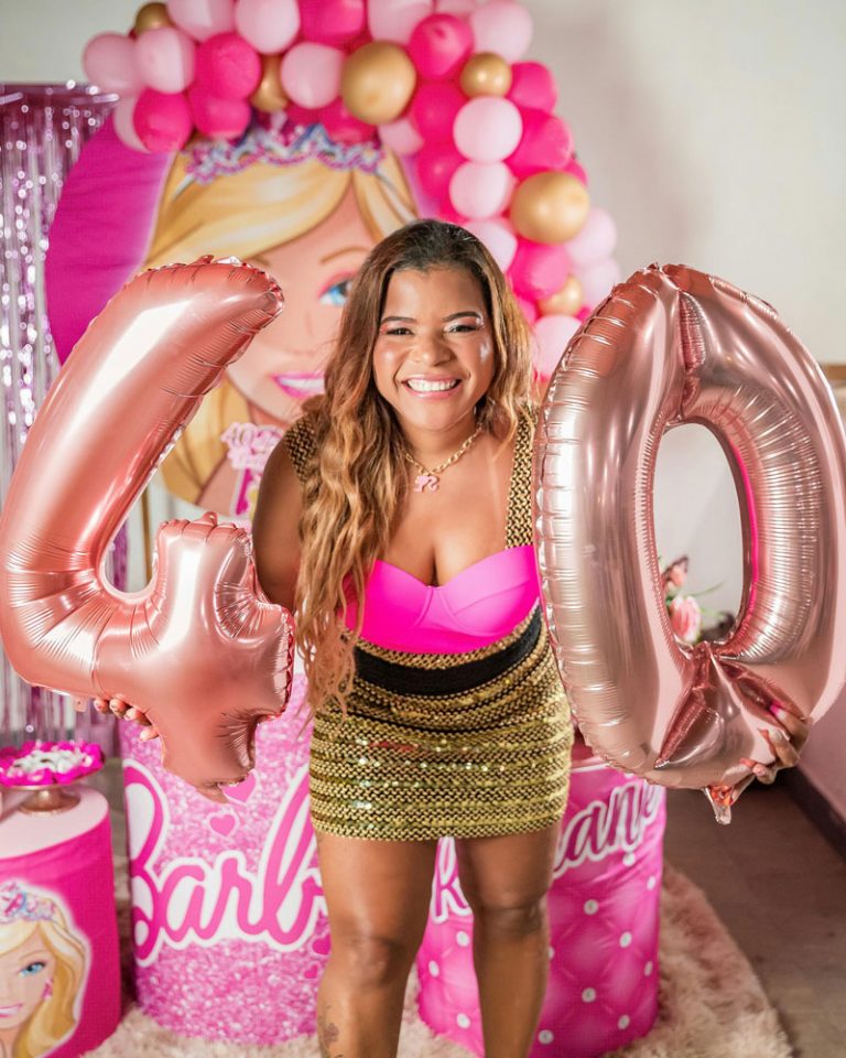 lady dressed in pink with 40 balloons