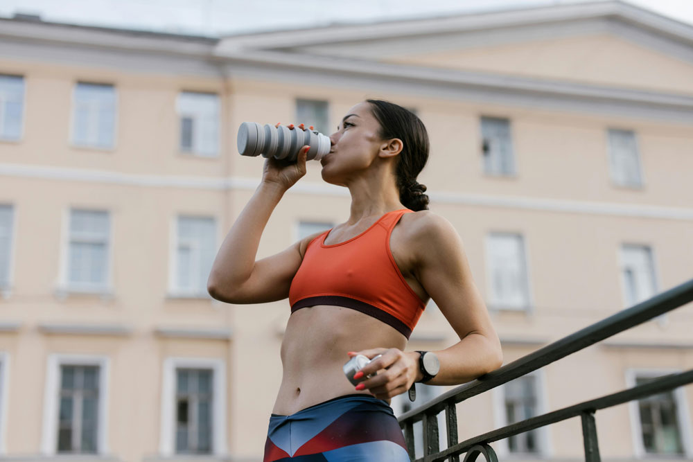 A woman running drinkiing water
