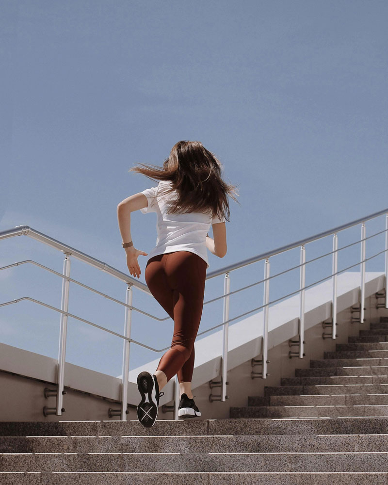 woman running up stairs