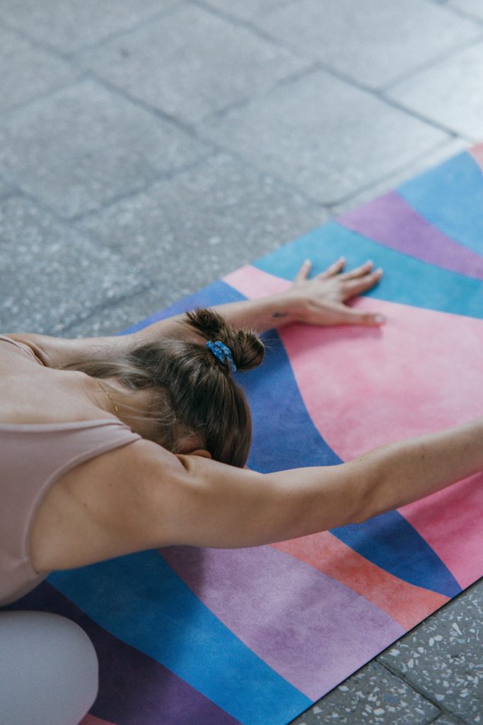 lady stretching on a yoga mat - Childs pose