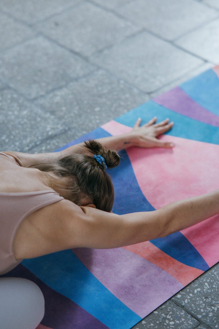 lady stretching on a yoga mat - Childs pose