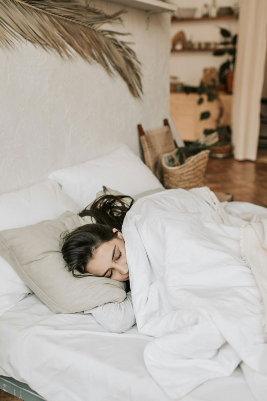 young woman asleep in bed