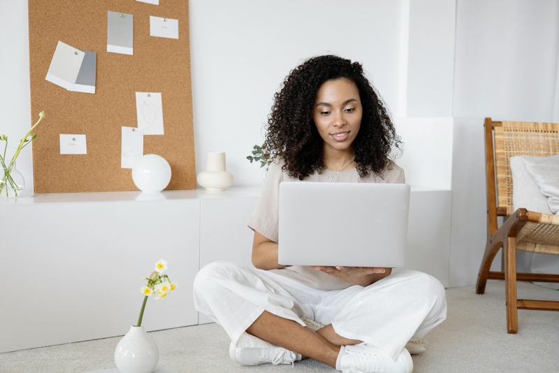 Confident woman on a laptop as part of her reset journey