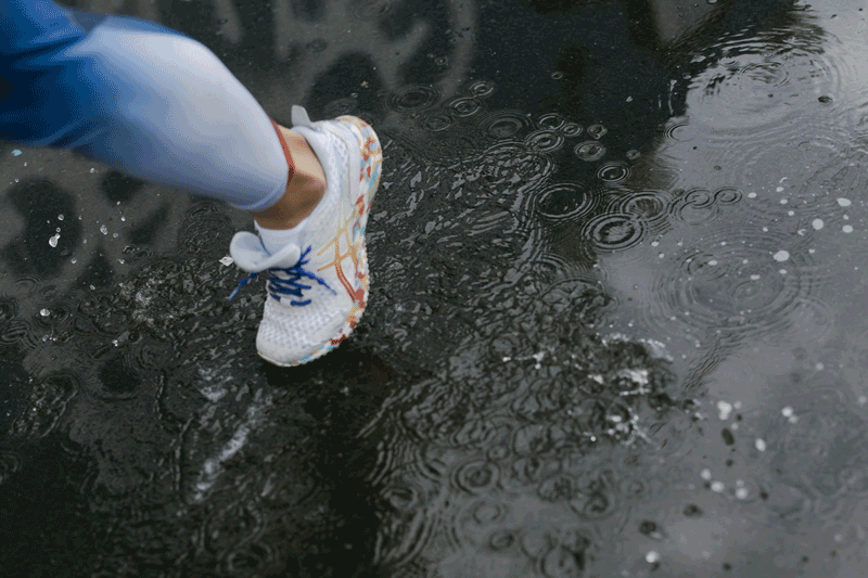 runner running through puddles of water 