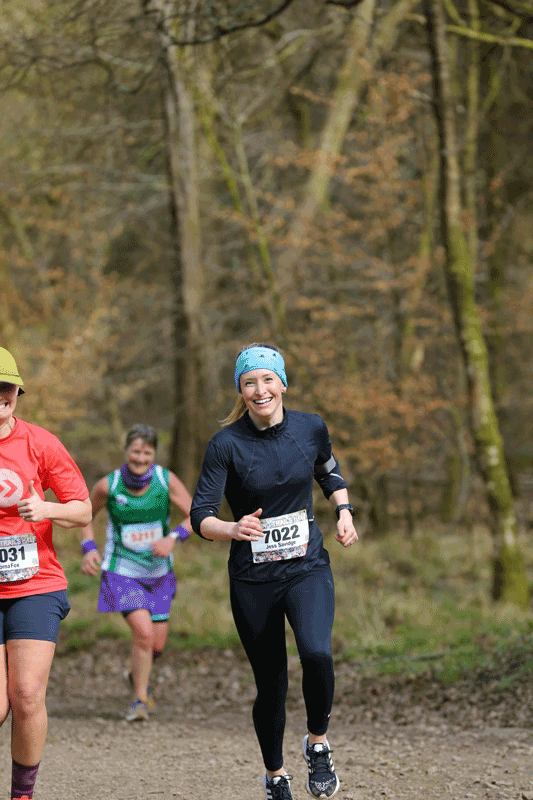 female running a trail race